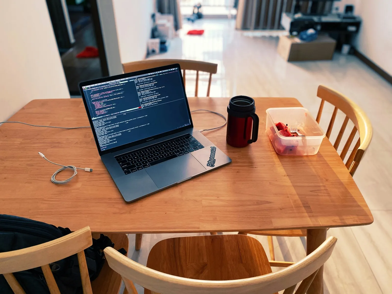 Developer working through complex ownership logic and percentage calculations at kitchen table