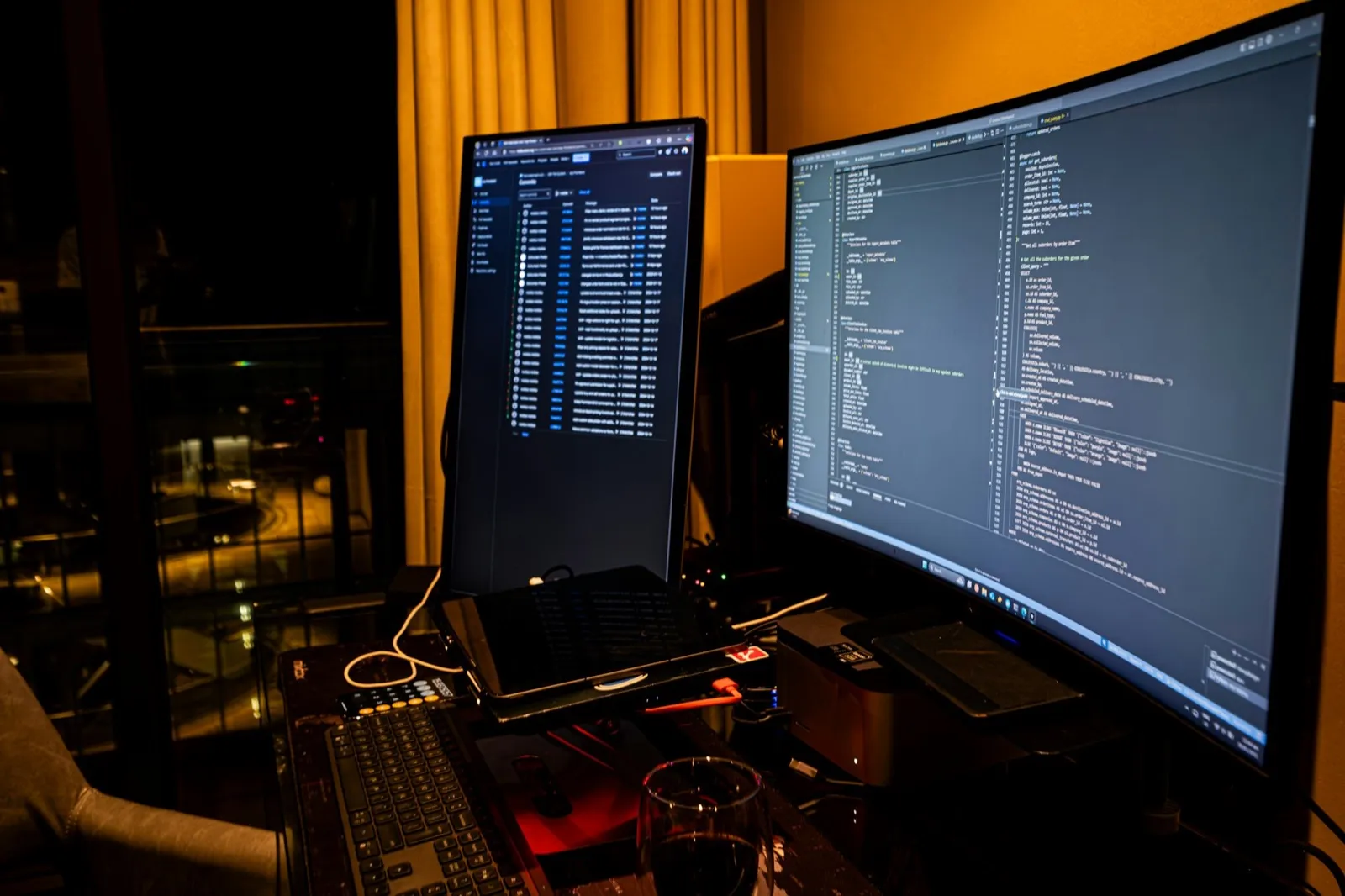 Night time coding setup with multiple monitors showing code