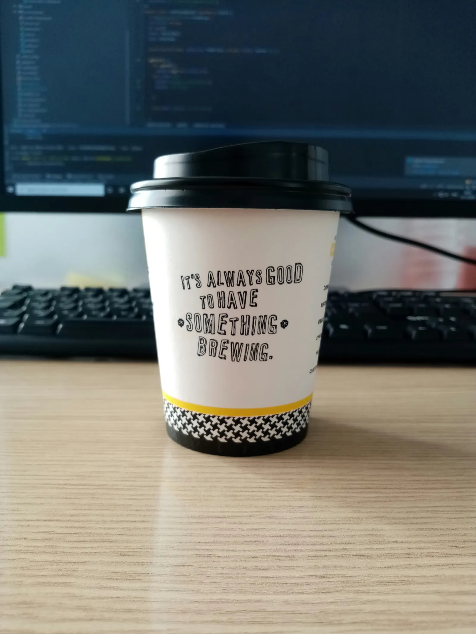 Coffee brewing while code runs in background, representing background job processing