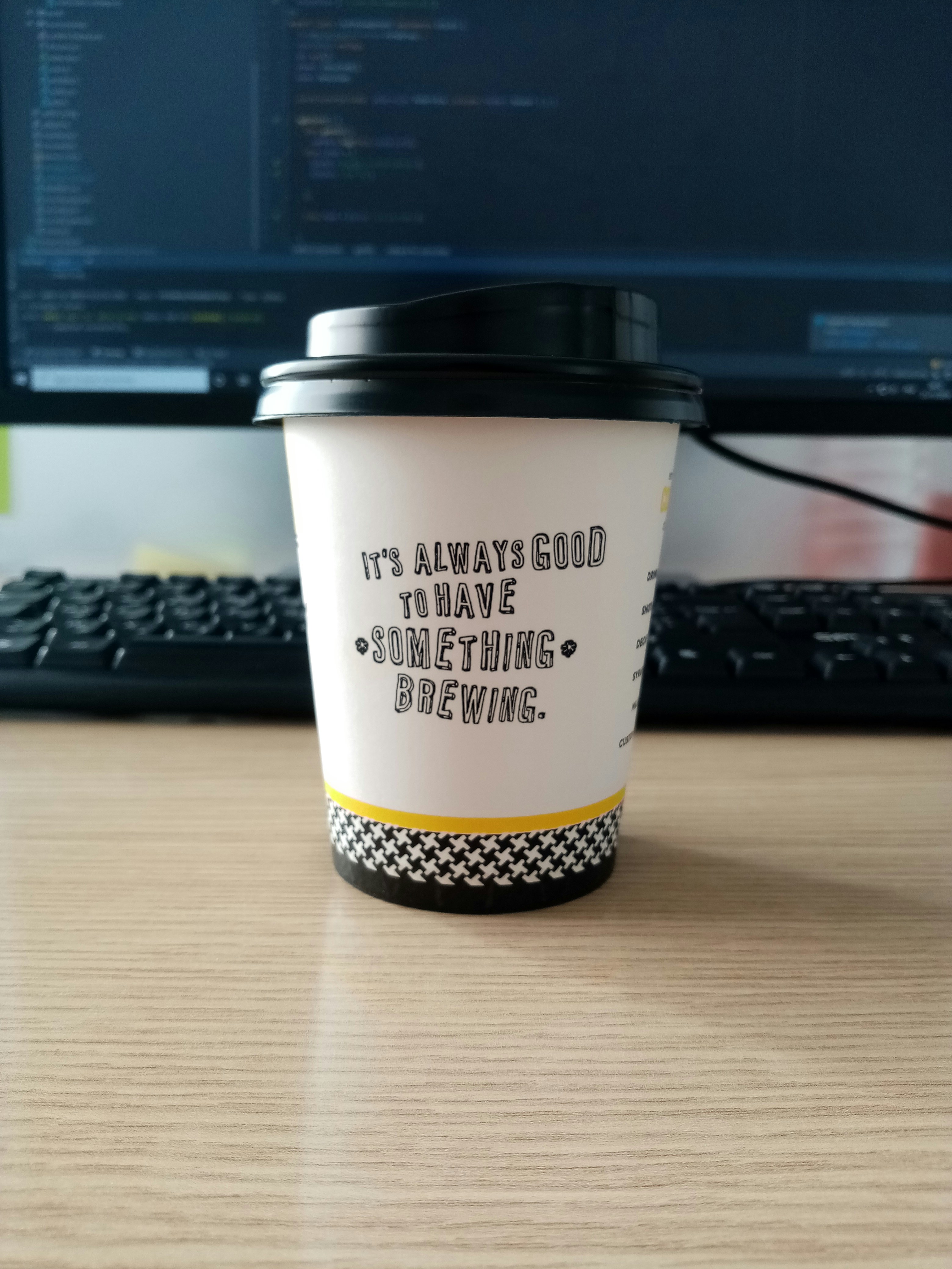 Coffee brewing while code runs in background, representing background job processing