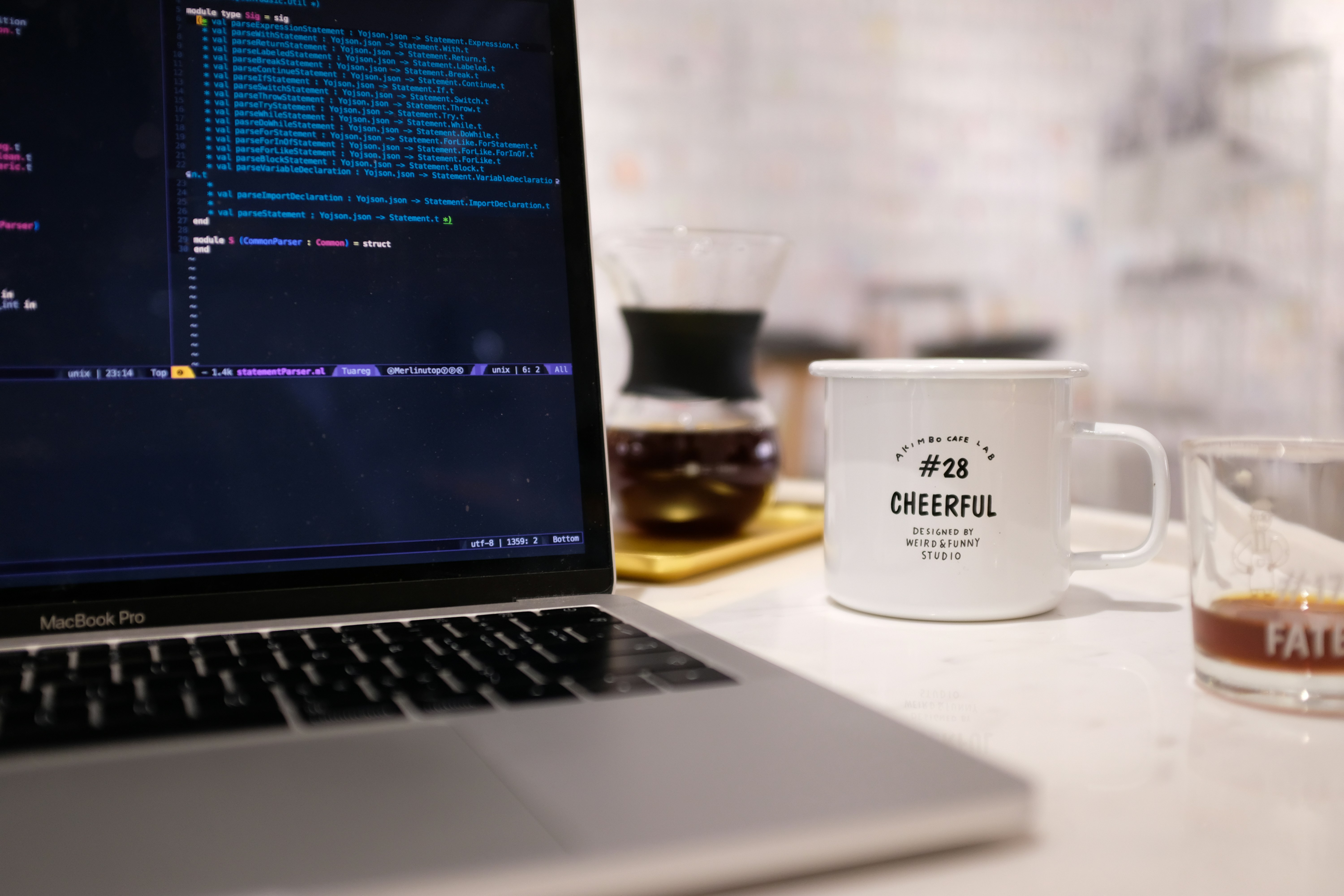 Developer debugging timing issues with coffee at workspace