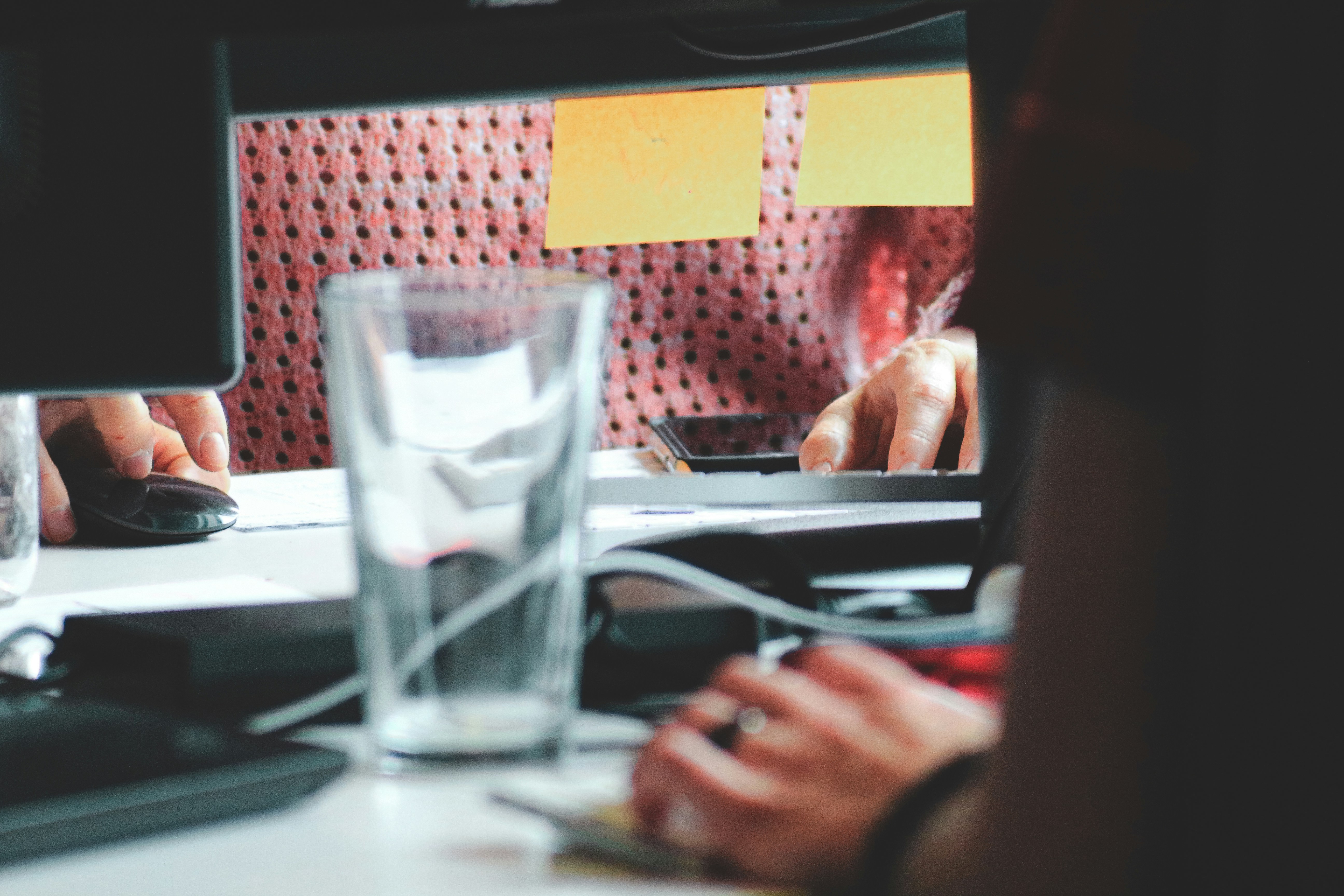 Developer focused on coding webhook infrastructure on laptop screen